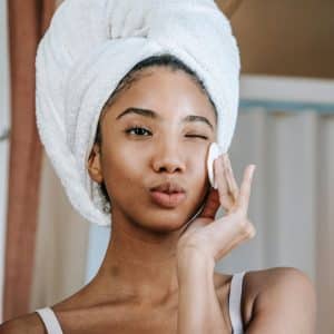 a woman looking at her skin