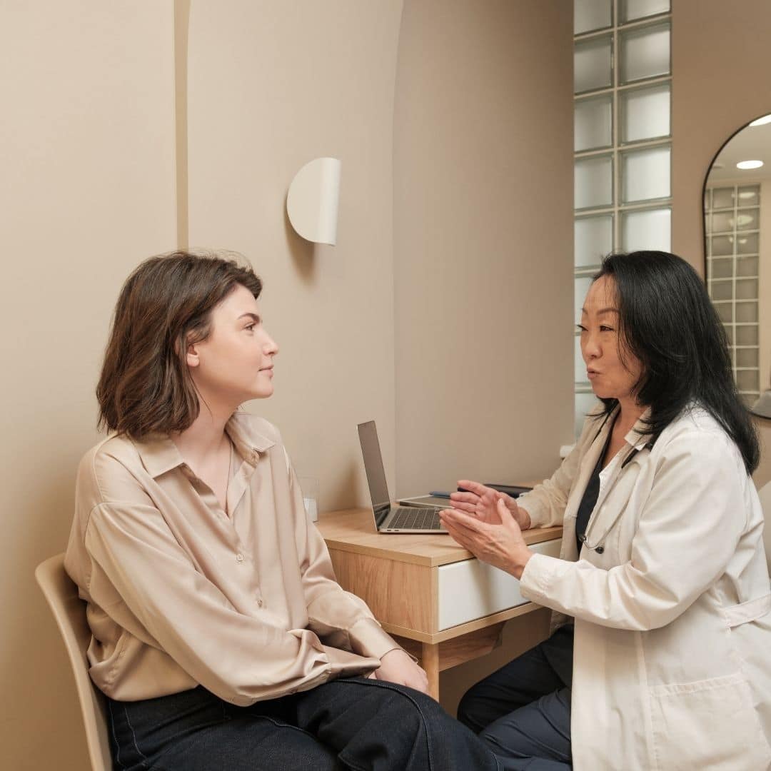 a man and a med spa esthetician sitting at a table